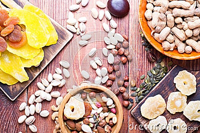 Nuts and dry fruit, in bowls, on boards Stock Photo