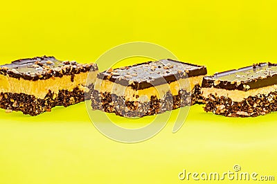 Nutty brownie bars on a yellow background Stock Photo