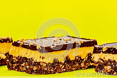 Nutty brownie bars on a yellow background. Dream bar Stock Photo