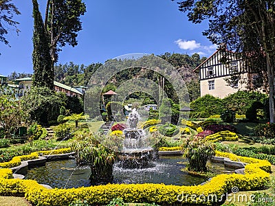 Nuwara Eliya, Sri Lanka - March 10, 2022: View of the territory of the Grand Hotel with landscaping. Jets of water pour from the Editorial Stock Photo