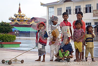 Nyaungshwe Inle Lake, Burma - December 4, 2012. Portrait of Burman children different age in colorful clothes with toys Editorial Stock Photo