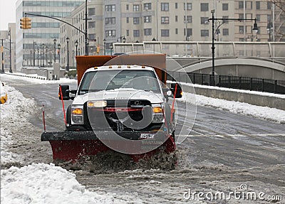 NYC Sanitation truck plowing snow in the Bronx Editorial Stock Photo