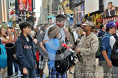 NYC: Soldier with Tourists in Times Square Editorial Stock Photo