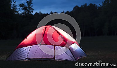 Nylon camping tent lighted after sundown Stock Photo