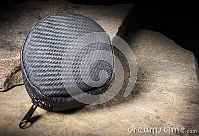 Nylon pouch for tactical gear on large stones Stock Photo