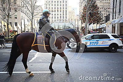 NYPD Mounted Unit police officer provides security at Rockefeller Plaza in Midtown Manhattan Editorial Stock Photo