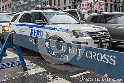 NYPD police vehicle and do not cross traffic barricade Editorial Stock Photo