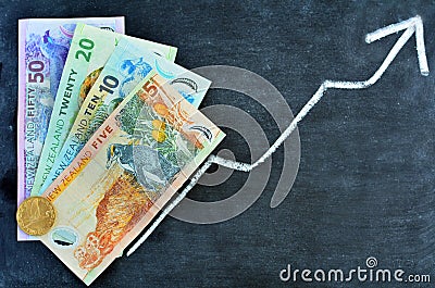 NZ Dollar banknotes with upward trend arrow Stock Photo