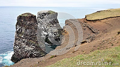 NÃºpskatla: Karl og SÃ¶lvavÃ¶f - Two basaltic rocks on the coast of Island Stock Photo