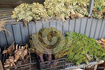 Oak, birch, juniper brooms for a bath. Selling on the market Stock Photo