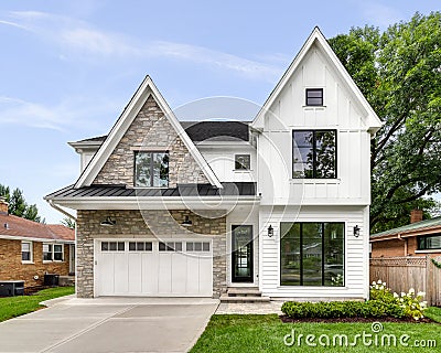 A modern farmhouse home with a white and brick exterior. Editorial Stock Photo