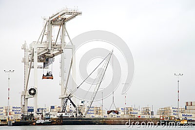 Tugboat PHILLIS T securing a barge ship against the docks at the Port of Oakland Editorial Stock Photo