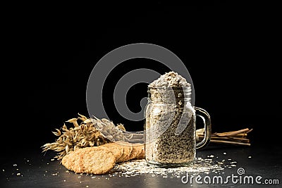 Oat bunch, cookies and flakes in flavouring jar Stock Photo