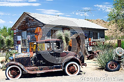 OATMAN ARIZONA, USA - AUGUST 7. 2009: American vintage car in front of abandoned wooden historic old gas station Editorial Stock Photo