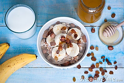 Oatmeal with bananas, raisins and honey Stock Photo