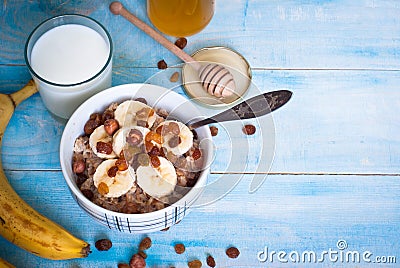 Oatmeal with bananas, raisins and honey Stock Photo