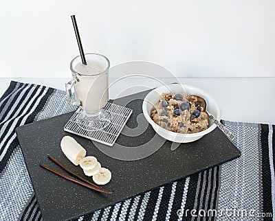 Oatmeal with Blueberries and Vanilla Banana Smoothie on Black Stock Photo