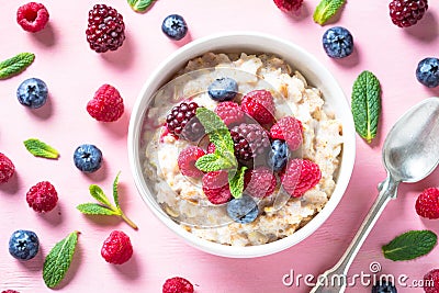Oatmeal cereal with milk and berries top view. Stock Photo