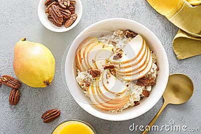 Oatmeal with cottage cheese, pecan nuts and pear for breakfast Stock Photo