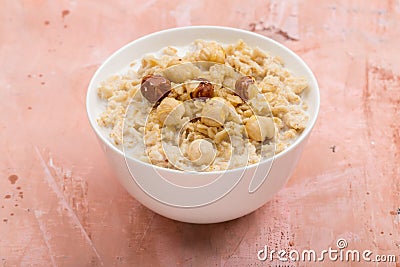 Oatmeal with hazelnut and honey on pink background Stock Photo