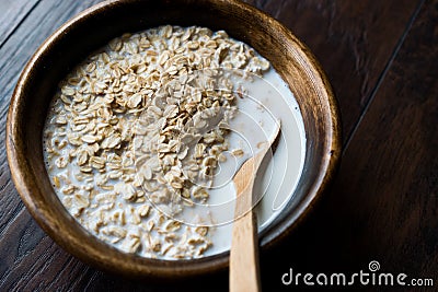 Oatmeal with Milk in Wooden Bowl / Plain Porridge Stock Photo