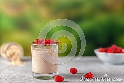 Healthy dietary food. Oatmeal milkshake with bananas and raspberries. Stock Photo