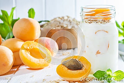 Oatmeal milkshake, smoothie or yogurt with fresh apricot on a white wooden background Stock Photo