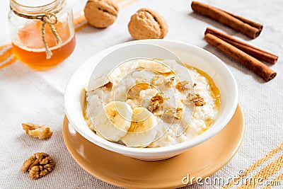 Oatmeal porridge with banana, nuts and honey Stock Photo