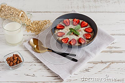 Oatmeal with strawberries and almond, healthy food, concept dietary food Stock Photo