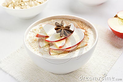 Oats porridge with red apple slices and cinnamon Stock Photo
