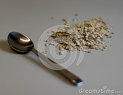 Oats with a spoon at the table Stock Photo