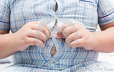 Obese fat boy overweight. Tight shirt of pajamas Stock Photo