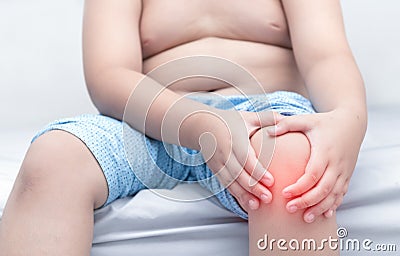 Obese fat boy suffering from knee pain Stock Photo