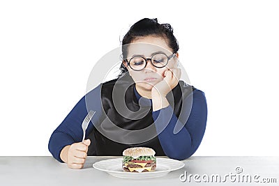 Obese female hesitate eat cheeseburger Stock Photo