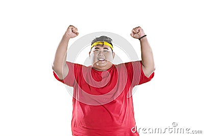 Obese man lifting hands to expressing his success Stock Photo