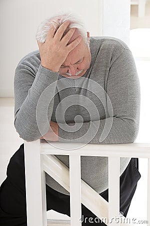 Obese man looking worried with hand on forehead Stock Photo