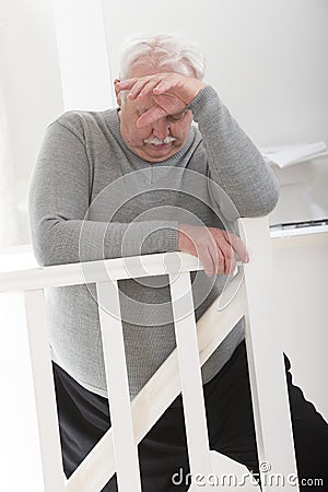 Obese man looking worried with hand on forehead Stock Photo