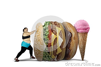 Obese woman punching fast foods Stock Photo