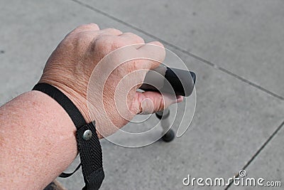 Obese Womans Hand Holding a Cane Stock Photo
