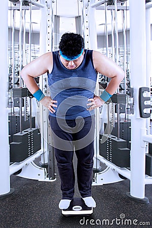 Obesity man measure his weight Stock Photo