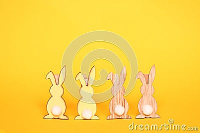 Object lovely wooden rabbits clip in two charactor turn back on yellow background with space for text. Easter background concept Stock Photo