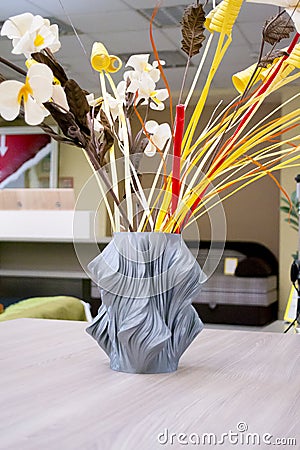 The object vase printed on the 3d printer stands on the table Stock Photo