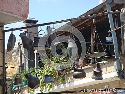 Objects of kitchen in cast iron suspended in a courtyard in Turkey. Stock Photo