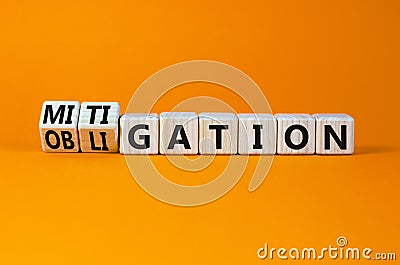 Obligation and mitigation symbol. Turned wooden cubes and changed the concept word obligation to mitigation. Beautiful orange Stock Photo