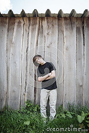 Oblique standing teenage boy Stock Photo