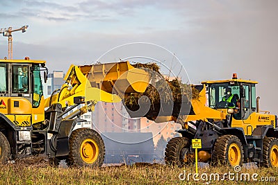 Obninsk, Russia - October 2019: Powerful excavators with raised buckets at a construction site Editorial Stock Photo