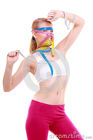 Obsessed fitness woman with a lot of colorful measure tapes Stock Photo