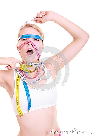 Obsessed fitness woman with a lot of colorful measure tapes Stock Photo