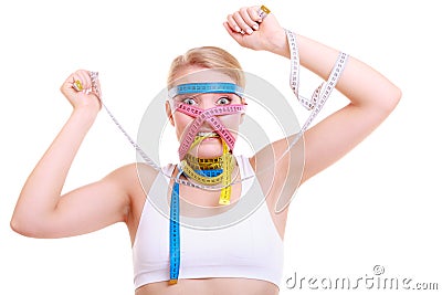 Obsessed fitness woman with a lot of colorful measure tapes Stock Photo