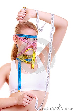 Obsessed fitness woman with a lot of colorful measure tapes Stock Photo